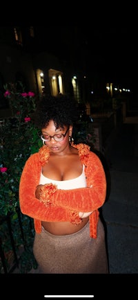 a woman wearing glasses and a skirt